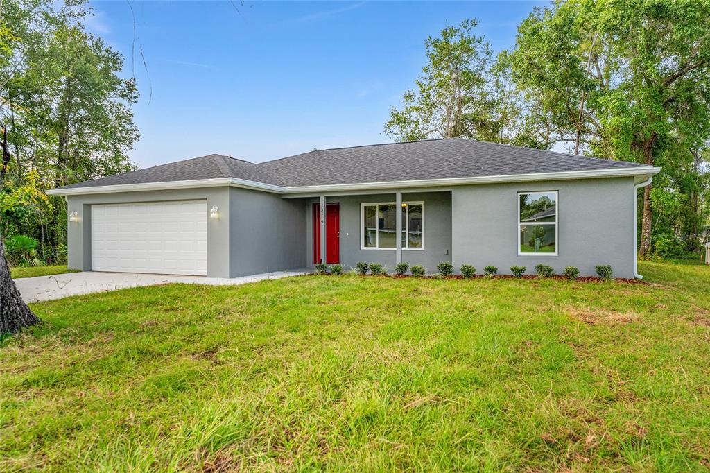 13119 Northeast 7th Loop Silver Springs, FL 34488 - Photo 4 of 51 a view of a house with a yard