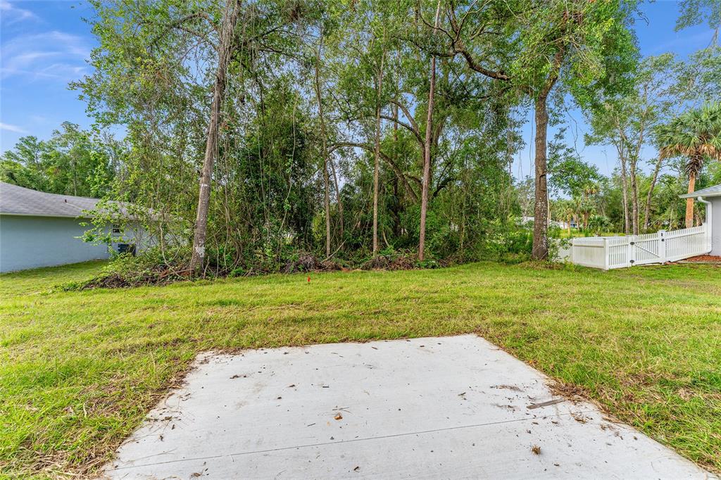 13119 Northeast 7th Loop Silver Springs, FL 34488 - Photo 44 of 51 a view of a backyard with large trees