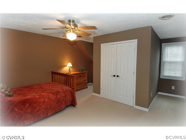 3030 Middlewood Road Midlothian, VA 23113 - Photo 12 of 20 a bedroom with a bed and a chandelier