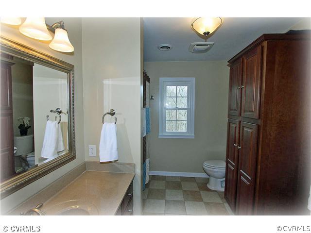3030 Middlewood Road Midlothian, VA 23113 - Photo 16 of 20 a bathroom with a sink a toilet and shower