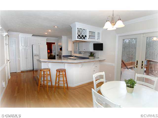 3030 Middlewood Road Midlothian, VA 23113 - Photo 6 of 20 a kitchen with kitchen island granite countertop a stove a sink a dining table and chairs