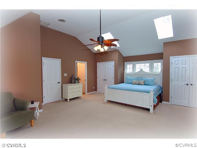 3030 Middlewood Road Midlothian, VA 23113 - Photo 9 of 20 a spacious bedroom with a bed and a chandelier
