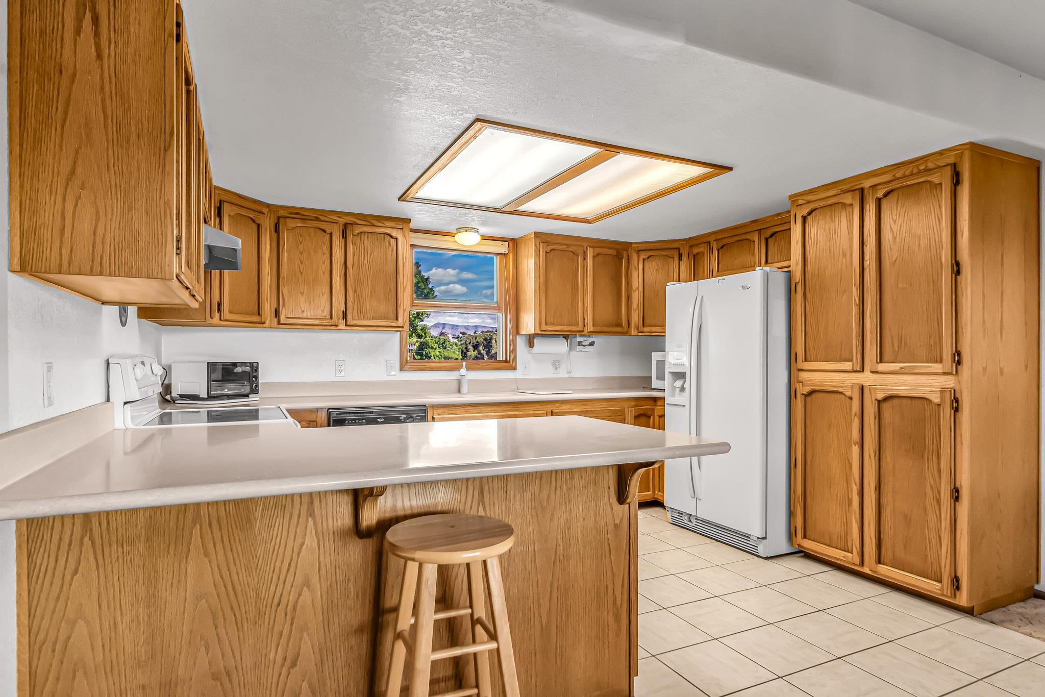 2648 H Road Grand Junction, CO 81506 - Photo 15 of 27 a kitchen with stainless steel appliances granite countertop a refrigerator a sink and a stove