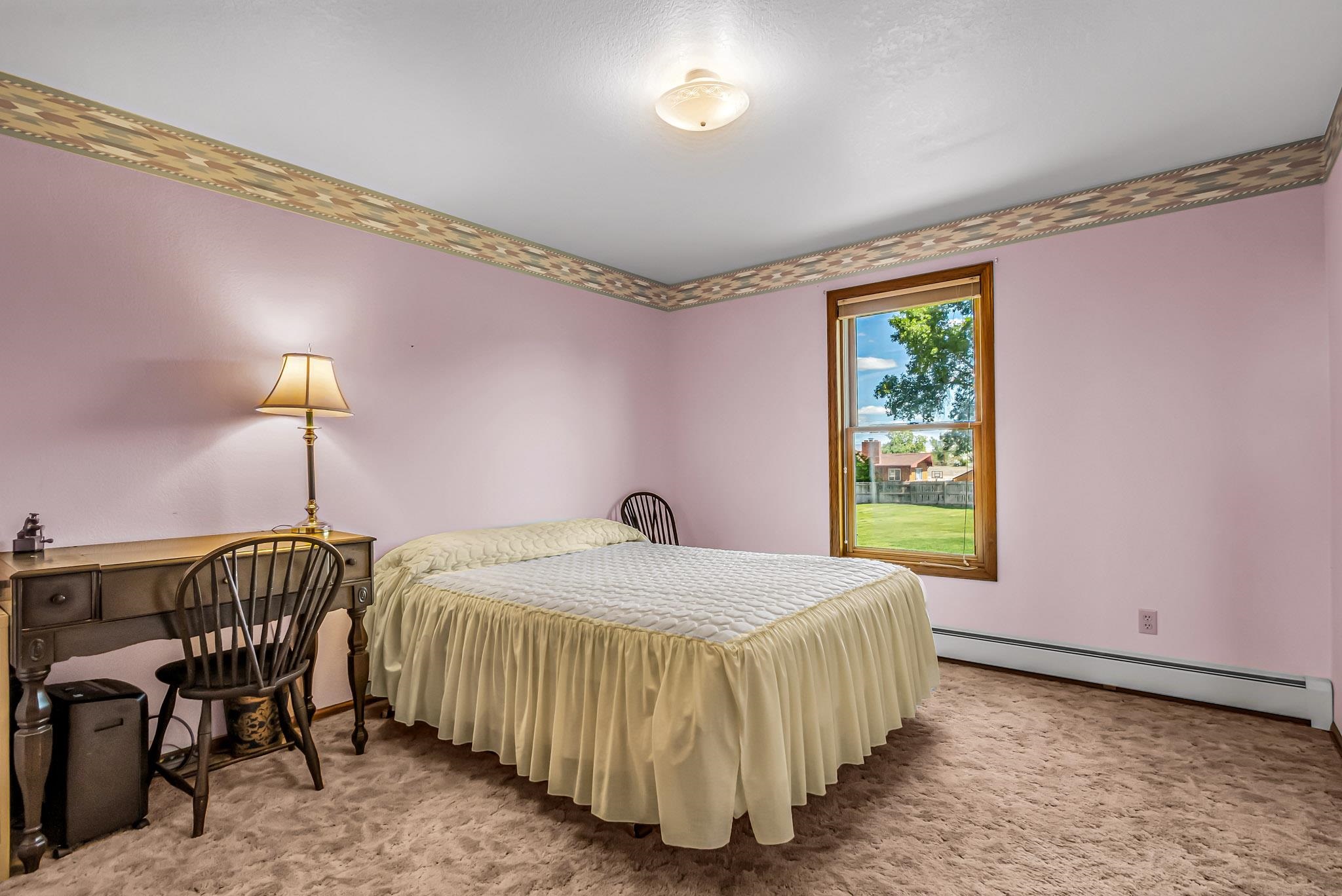 2648 H Road Grand Junction, CO 81506 - Photo 25 of 27 a bedroom with a bed and a table