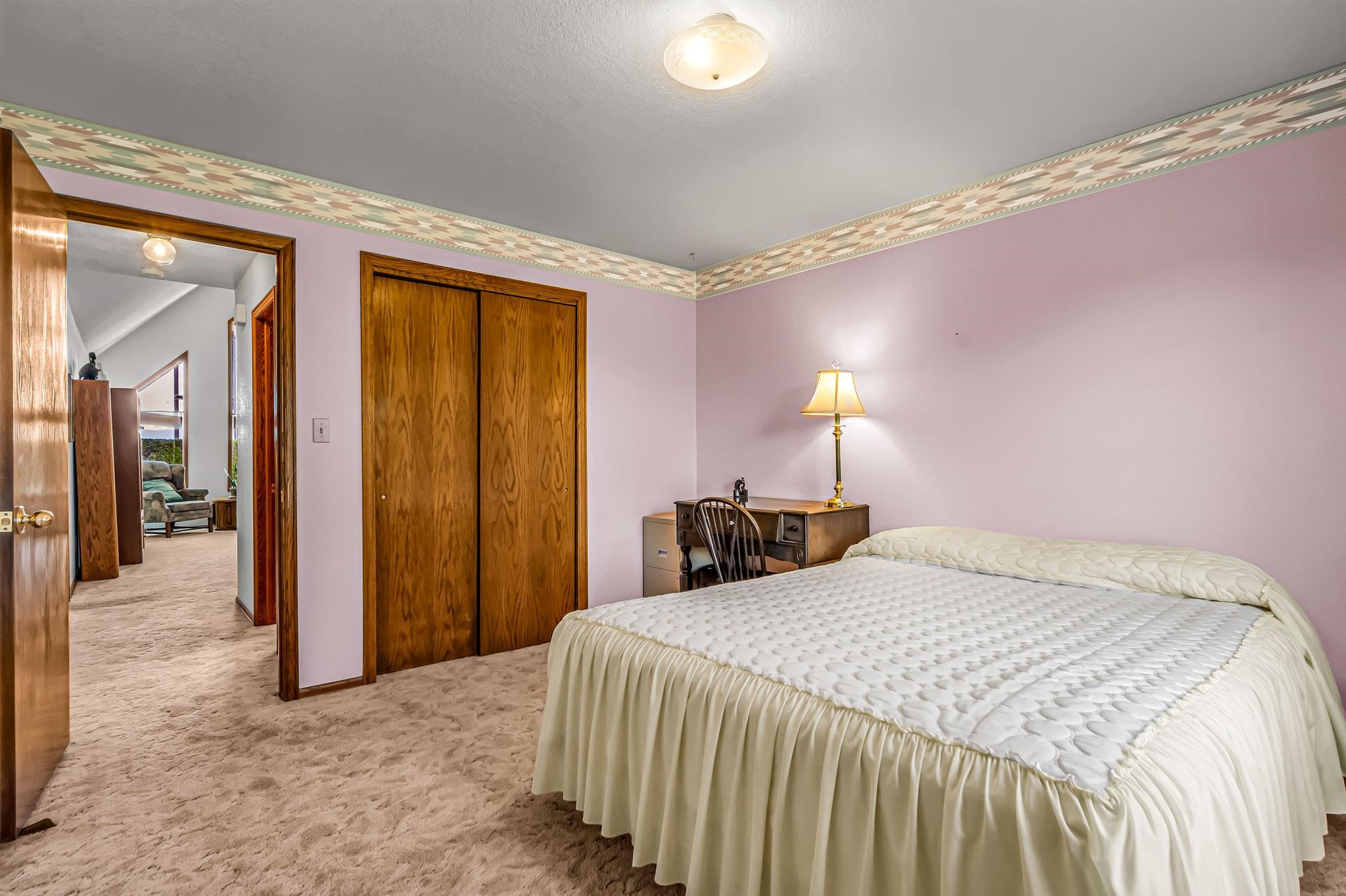 2648 H Road Grand Junction, CO 81506 - Photo 26 of 27 a bedroom with a bed and a lamp