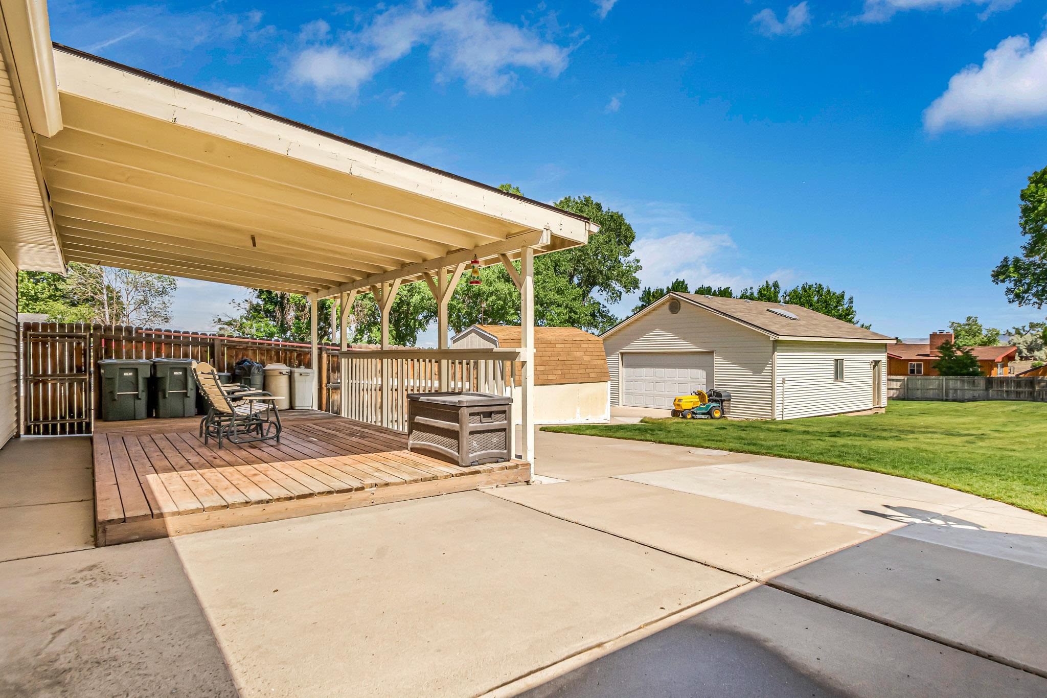 2648 H Road Grand Junction, CO 81506 - Photo 8 of 27 a view of a patio with a table and chairs under an umbrella