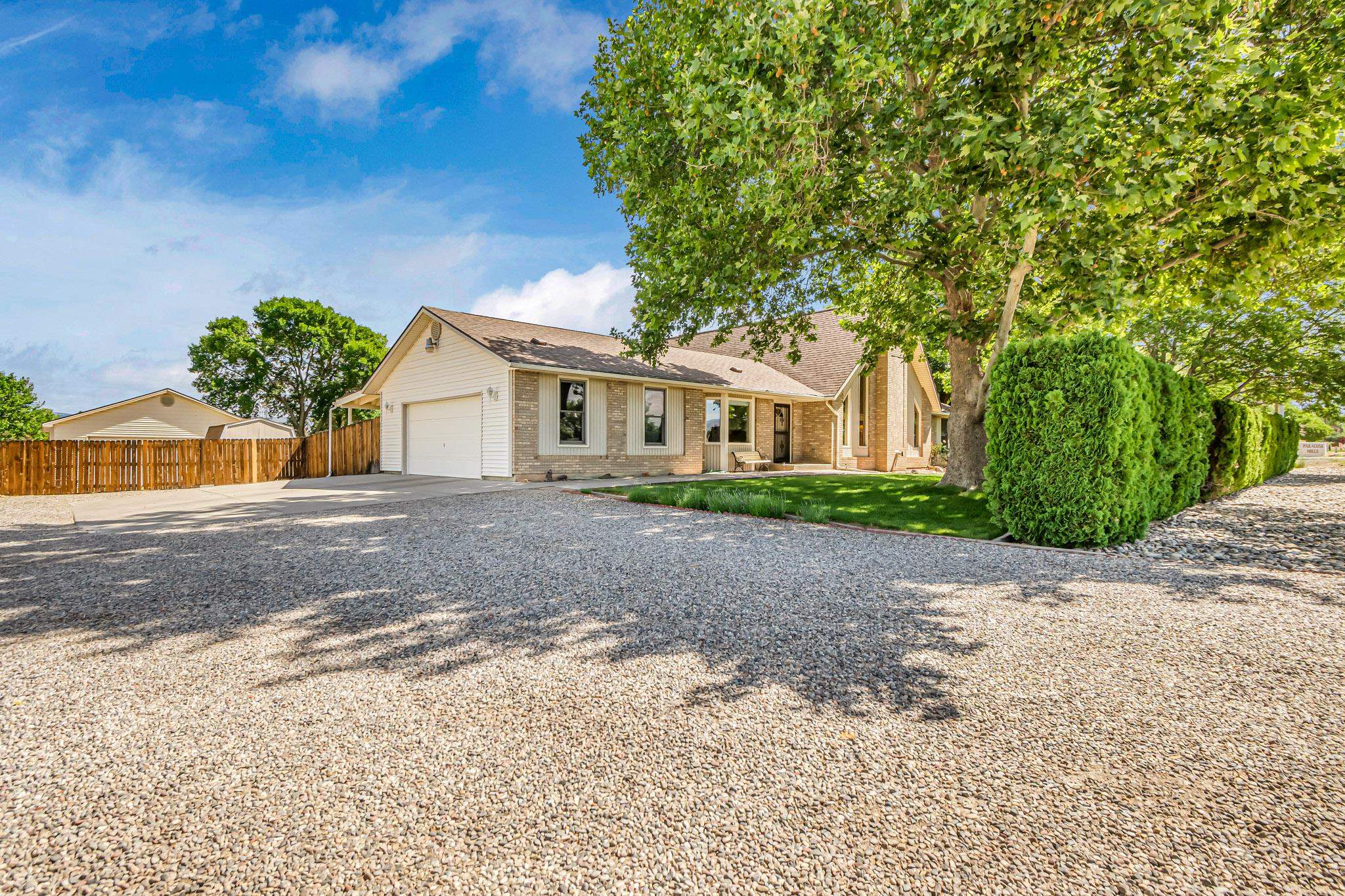 2648 H Road Grand Junction, CO 81506 - Photo 9 of 27 a front view of a house with a yard and a garage