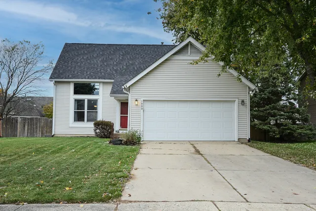a front view of house with yard and trees around