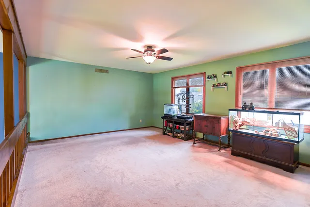 an empty room with windows and furniture