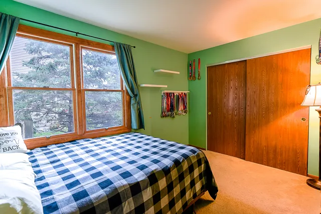 a bedroom with a bed and a window