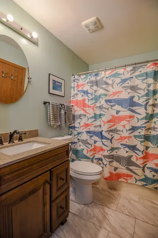 a view of bathroom with a sink and a mirror