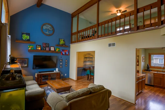a living room with furniture a flat screen tv and a fireplace