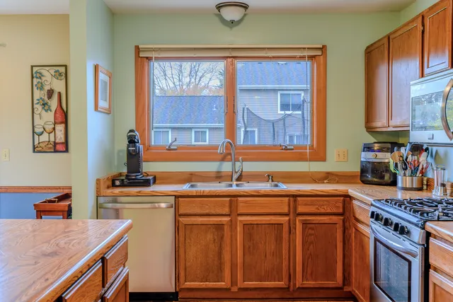 a kitchen with stainless steel appliances granite countertop a sink stove and cabinets