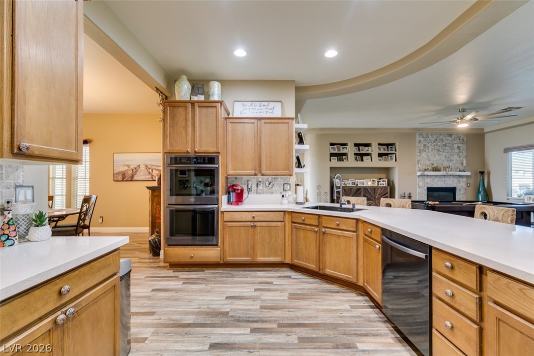 7524 Midnight Rambler Street Las Vegas, NV 89149 - Photo 22 of 51 A well-appointed kitchen features warm wooden cabinetry, modern appliances, and a seamless flow into the adjacent living space.