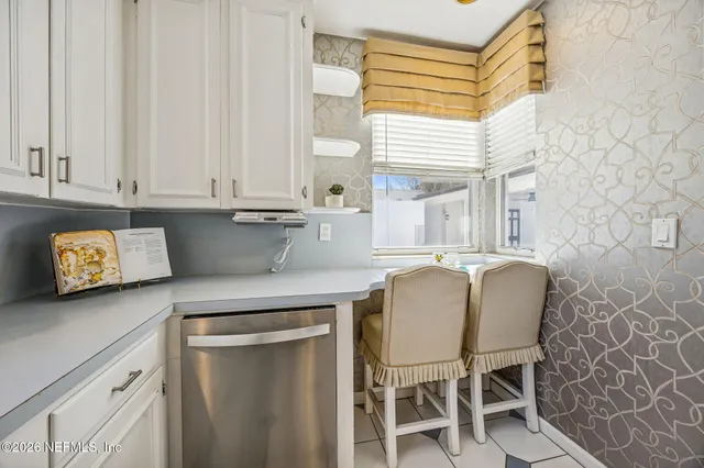 a kitchen with stainless steel appliances granite countertop a sink and a refrigerator