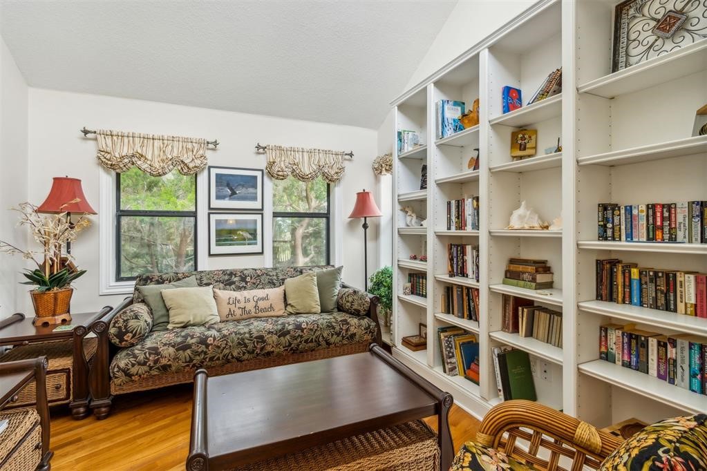 3119 Sea Marsh Road Fernandina Beach, FL 32034 - Photo 23 of 41 a living room with furniture and a book shelf