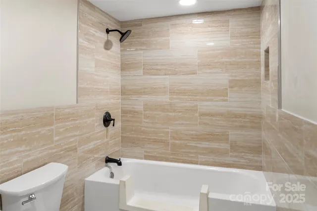 a bathroom with a bathtub and a toilet