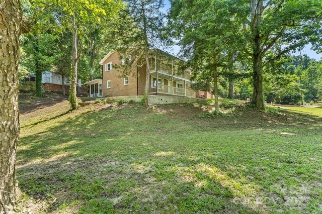 a backyard of a house with table and chairs