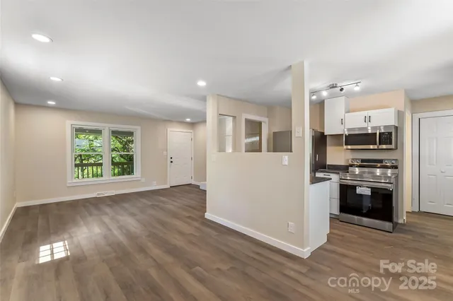 a kitchen with stainless steel appliances a refrigerator and a stove top oven