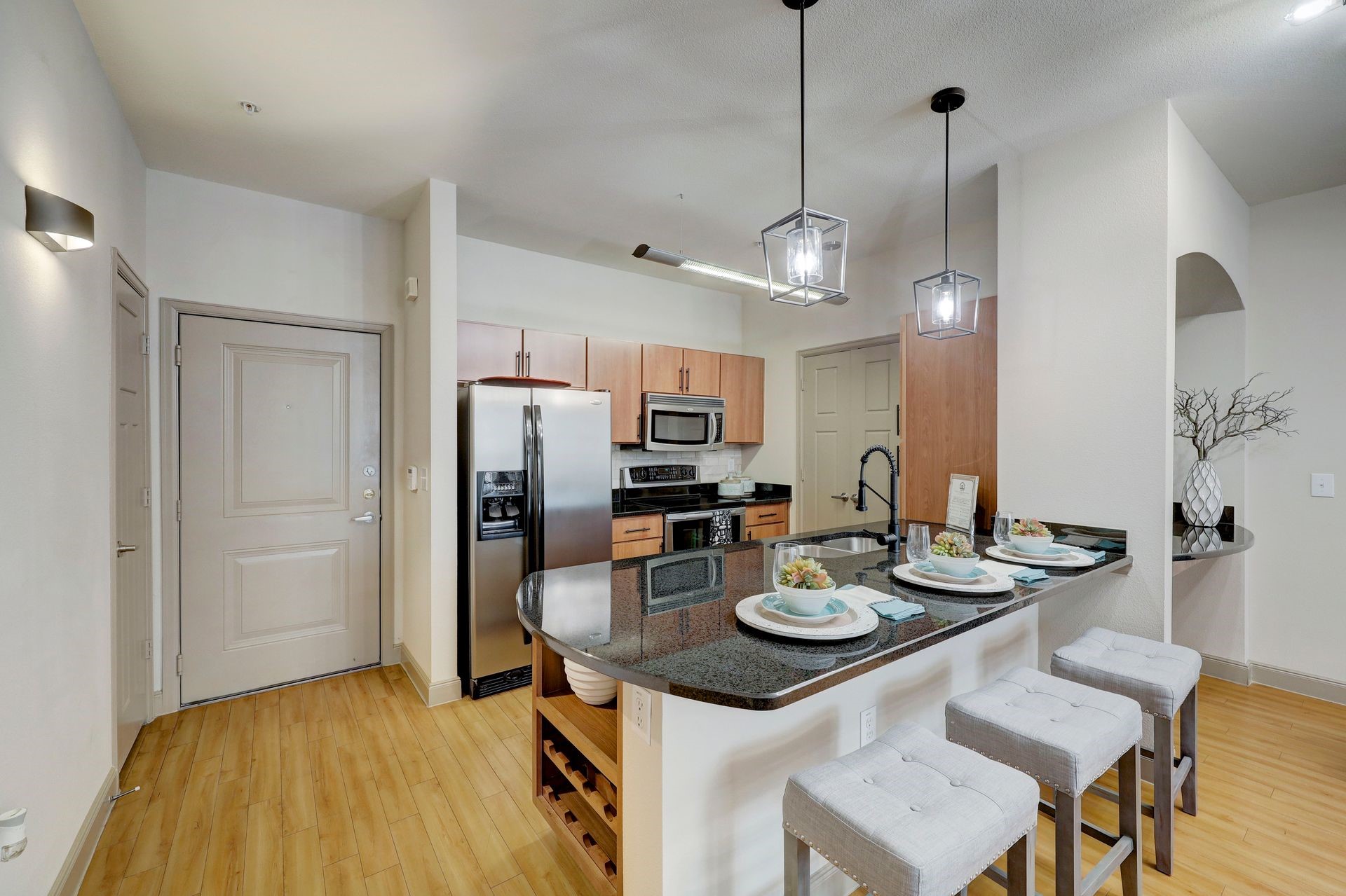 2401 South Gessner Road, Unit A Houston, TX 77063 - Photo 10 of 11 a view of a dining room and kitchen with a table chairs
