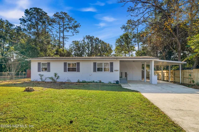 a view of a house with swimming pool and a yard