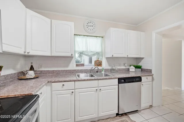 a view of a hallway to a room and a mirror