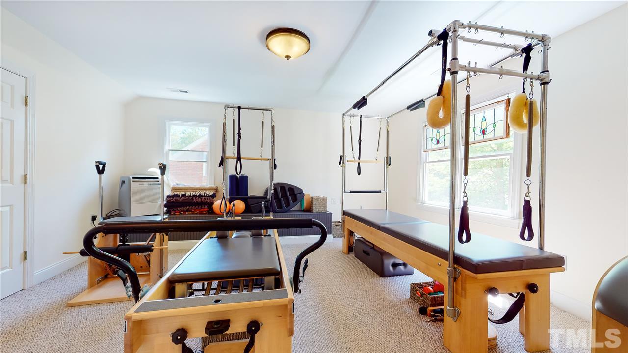 2621 Van Dyke Avenue Raleigh, NC 27607 - Photo 17 of 24 a living room with furniture a window and gym equipment