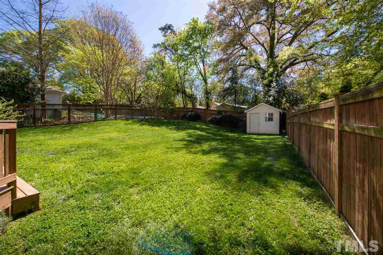 2621 Van Dyke Avenue Raleigh, NC 27607 - Photo 21 of 24 a view of a backyard with large trees and a lots of flower plants