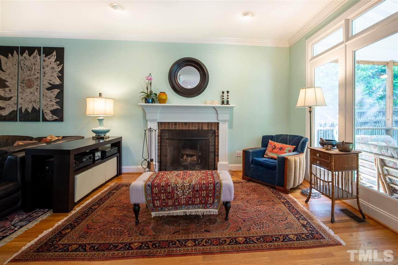 2621 Van Dyke Avenue Raleigh, NC 27607 - Photo 8 of 24 a living room with furniture a rug a fireplace and a large window