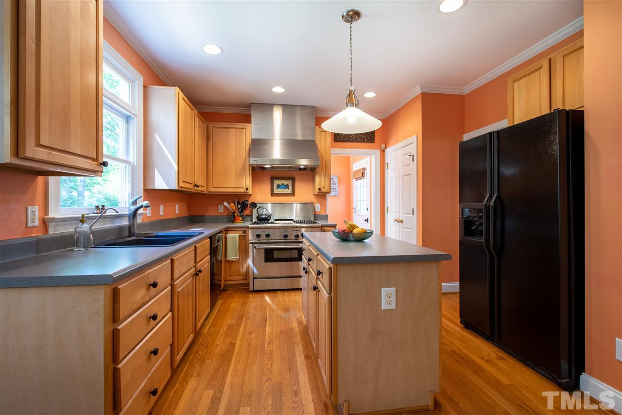 2621 Van Dyke Avenue Raleigh, NC 27607 - Photo 9 of 24 a kitchen with stainless steel appliances a stove a refrigerator and a sink
