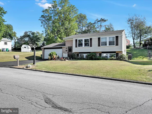 a view of house with outdoor space and garden