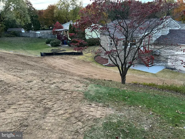 a view of house with outdoor space and car parked