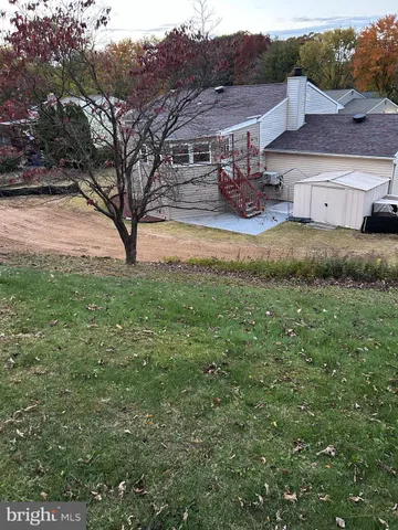 a view of a backyard with large trees