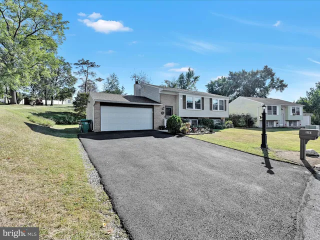 a front view of a house with plants