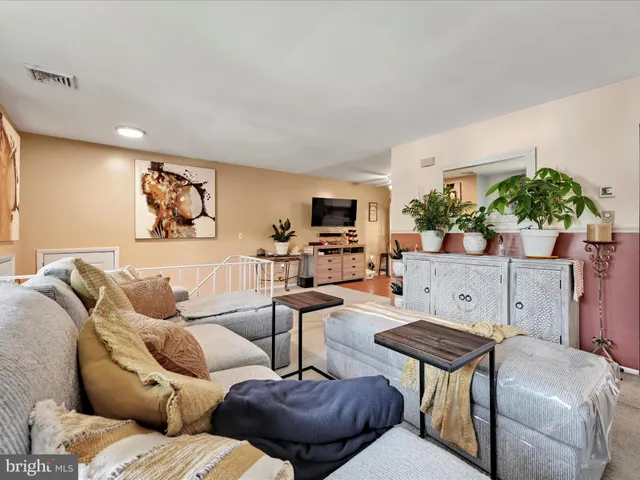 a dining room with furniture a rug and a large window