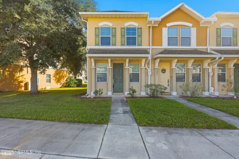 front view of a brick house with a yard
