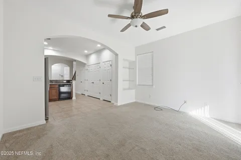 a view of a kitchen with wooden cabinet and a sink