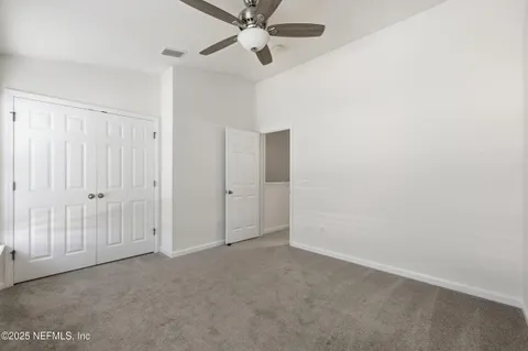 a view of a room with a ceiling fan