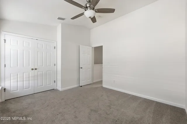 a view of a room with a ceiling fan