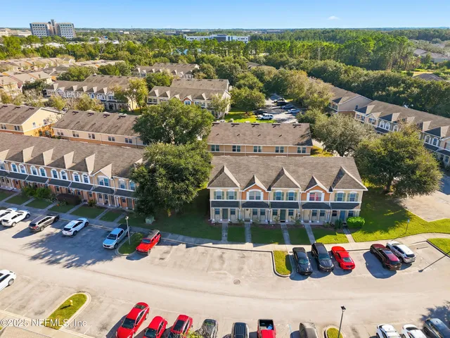 an aerial view of a tennis ground with a large tree