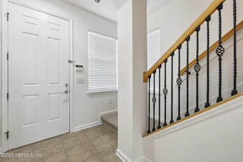 a kitchen with granite countertop a refrigerator stove and microwave