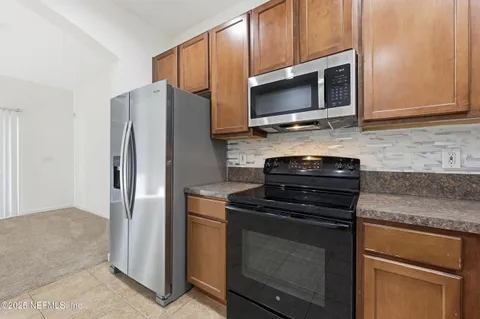 a view of a kitchen with a sink and cabinet