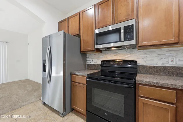 a view of a kitchen with a sink and cabinet