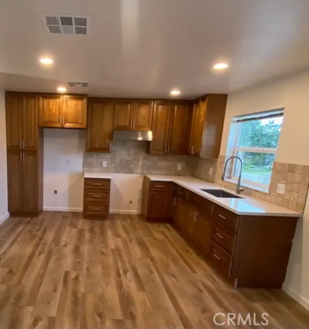 a kitchen with a sink and a stove top oven