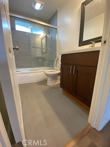 a bathroom with a toilet and a mirror