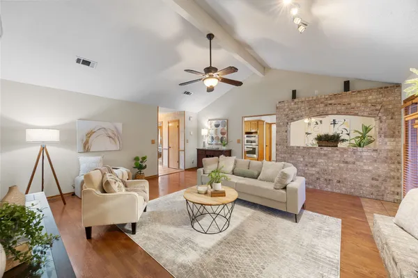 a living room with furniture fireplace and a chandelier