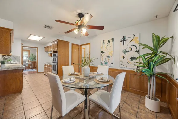 a view of a dining room with furniture and a potted plant