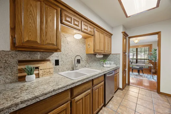 a kitchen with stainless steel appliances granite countertop a sink and cabinets