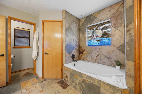a bathroom with a tub and shower