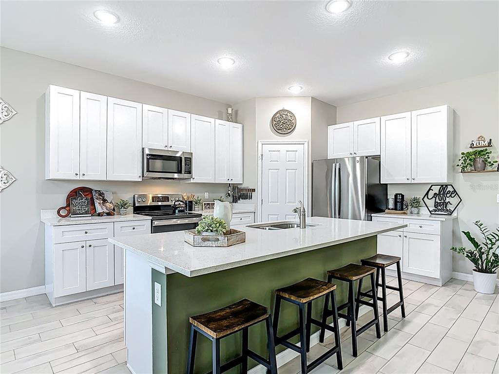 39641 Royal Trails Road Eustis, FL 32736 - Photo 13 of 63 a kitchen with appliances a sink cabinets and a counter top space